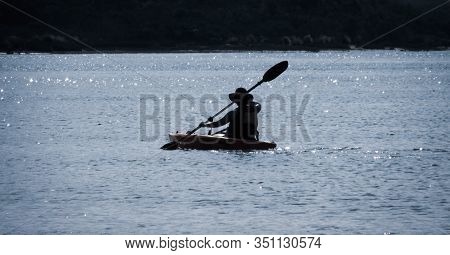 Venus Bay, Au - Jan 3,  2020: Silhouette Of People Doing Water Sport Activity In South Gippsland. Ap