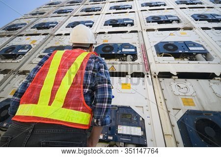Young Man Reefer Technician Is Monitoring Reefer Container At The Container Storage