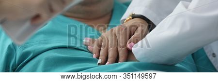 Close-up Of Refined Female Hand Doing Emergency Heart Massage By Hand In Hospital Ward. Assistant Ma