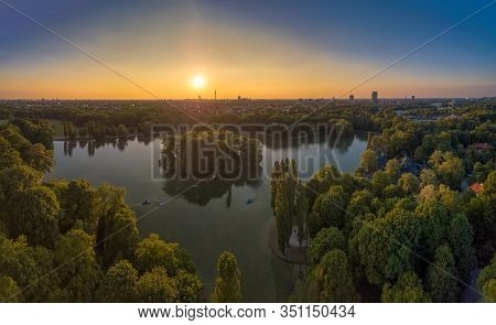 Sunset View Over A Lake In A Park Of Munich In Germany.