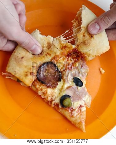 Slice Of Pizza With Hum, Sausage,cucumber, Olives Onion And Cheese Crust