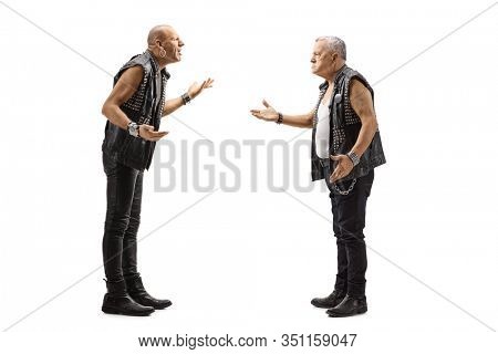 Full length profile shot of two punkers arguing isolated on white background