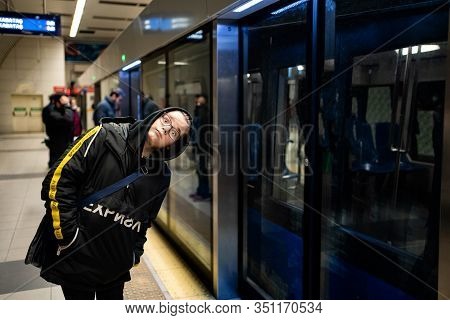 Teenager In Glasses And Black Clothes Waiting For The Metro Train.