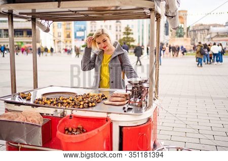 Blonde Girl On A Tray With Roasted Chestnuts On The Street In Istanbul