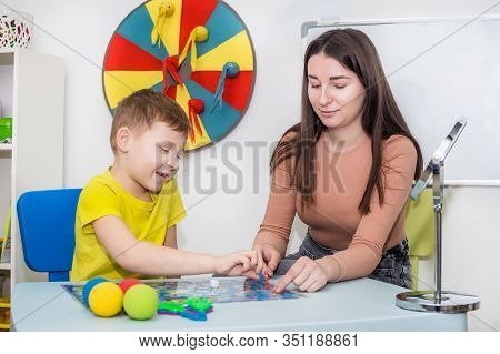 Young Woman Speech Therapist Is Engaged In The Office With A Child