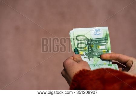 Hand Couting Holding And Showing Euro Money Or Giving Money. World Money Concept, 100 Euro Banknotes
