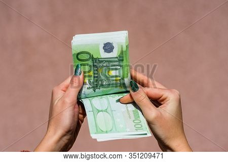 Hand Couting Holding And Showing Euro Money Or Giving Money. World Money Concept, 100 Euro Banknotes