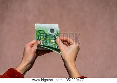 Hand Couting Holding And Showing Euro Money Or Giving Money. World Money Concept, 100 Euro Banknotes