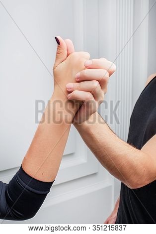 Close Up Of Delicate Tender Hands Of Dancers. Ballroom Dancers On The Dance Floor.