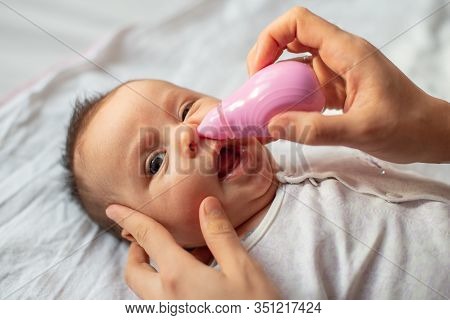 Mother Using Baby Nasal Aspirator Mucus Nose Suction