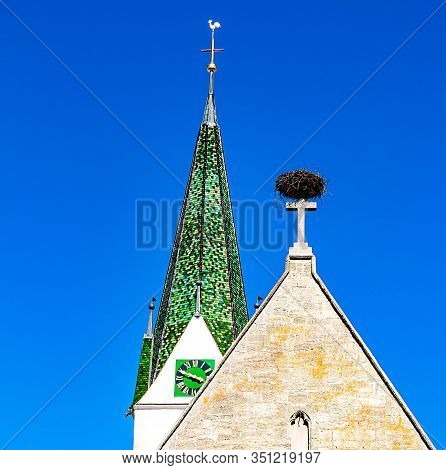 The Top Of St. John Baptist Church With Stork Nest In Bad Saulgau, Germany