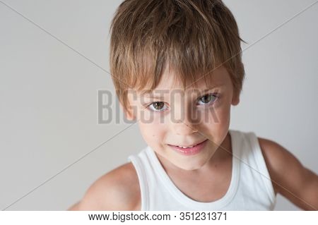 Happy Adorable Cheerful Little Kid In White Tank Top