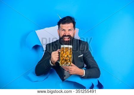 Lager And Dark Beer. Stylish Man Drinks Beer. Oktoberfest. Bearded Man Holds Craft Beer Looking Thro