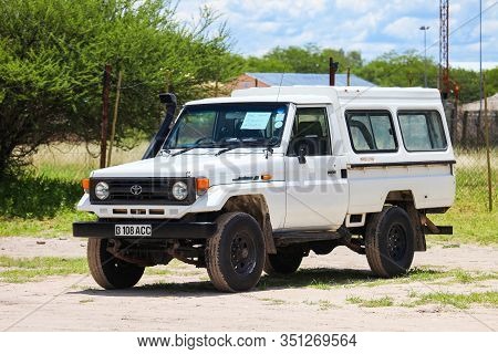 Maun, Botswana - February 9, 2020: White Pickup Truck Toyota Land Cruiser 70 In The Town Street.