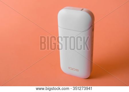 White Iqos Electronic Cigarettes Isolated On Orange Background.