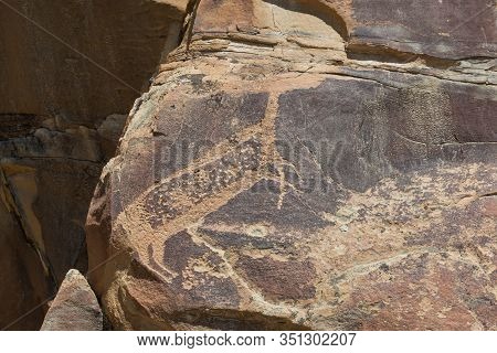 A Large Deer Missing Its Head Carved Into Ancient Sandstone Rock That Is Cracking And Eroding Over T