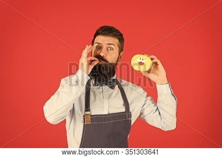 You Will Lick Your Fingers. Bearded Man Enjoying Sweet Taste Of Doughnut On Red Background. Baker Ea