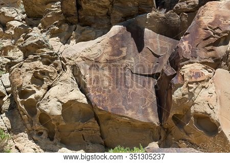 Strange Shapes And Figures That Have Been Carved Into The Ancient Sandstone Rocks At Legend Rock Sta
