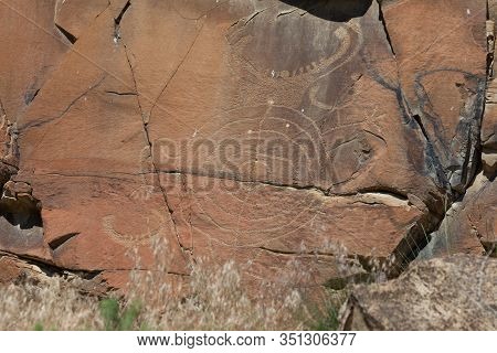 Strange Shapes And Figures That Have Been Carved Into The Ancient Sandstone Rocks At Legend Rock Sta