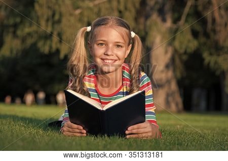 Theres Nothing Like Reading. Happy Reader. Cute Reader Read Book On Green Grass. Small Reader Enjoy 