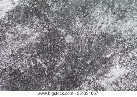 Texutured Ise Surface Of Frozen Lake. Close Up. Scattered White Snow Around. Winter Background.