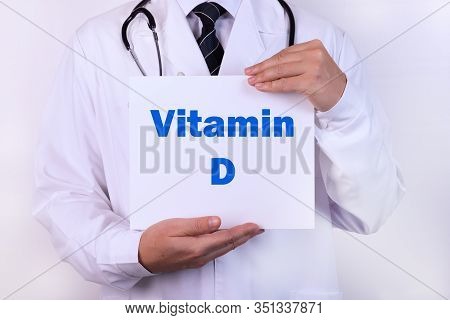 Doctor Holds A Sign Of Vitamin D, Medical Concept.