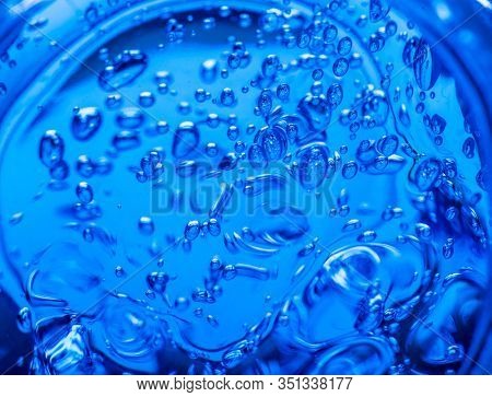 Liquid blue gel bubbles. Polymer gel. Silica gel. Balls of blue hydrogel. Crystal liquid ball with reflection. Texture background. Close up macro. Soapsuds background with air bubbles