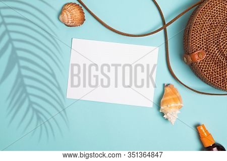 Seashells, Sunscreen And Ratan Bag On Blue Background, Top View.