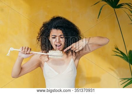 Vivacious Emotional Frustrated Annoyed Multi Ethnic Woman In Beige Top On Yellow Background, Having 