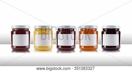A Group Jars Containing Jams And Preserves, Including Rasperry, Strawberry, Marmalade, Chutney And R