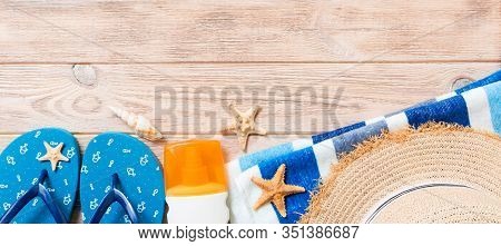 Flip Flops, Straw Hat, Starfish, Sunscreen Bottle, Body Lotion Spray On Wooden Background Top View B