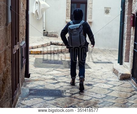 Tourist walking charming narow streets of Polignano a Mare, Puglia, Italy