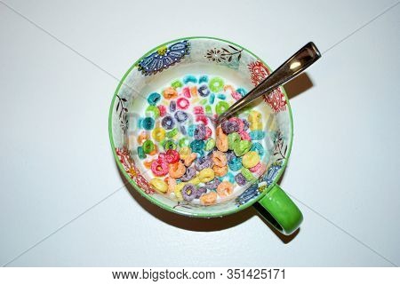 Close Up Of A Bowl Full Of Fruit Flavored Loops Of Sugar Ready To Eat Breakfast Cereal With A Spoon