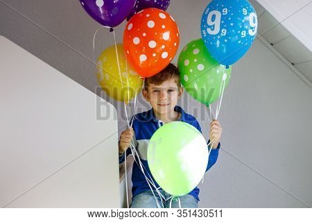 Portrait Of Happy Kid Boy With Bunch On Colorful Air Balloons On His Birthday. Smiling School Child 
