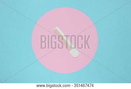 White Hair Combon On Blue Pastel Background With Pink Pastel Circle. Creative Minimalistic Beauty An