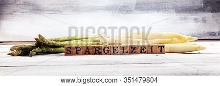 White And Green Asparagus On Background With Spargelzeit Wooden Letter.