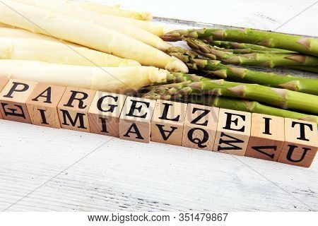 White And Green Asparagus On Background With Spargelzeit Wooden Letter.