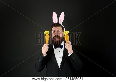 Handsome Man Wear Bunny Costume Accessory. Celebration Easter Holiday. Carrot Is Good For Your Teeth