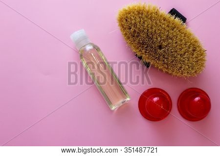 Spa Organic Brush For Dry Massage And A Bottle Of Body Oil On Pink Background. Cactus Brush And Jar 