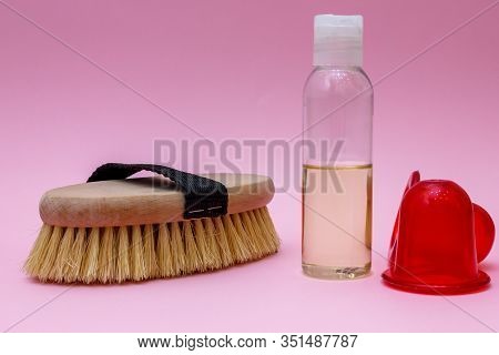 Spa Organic Brush For Dry Massage And A Bottle Of Body Oil On Pink Background. Cactus Brush And Jar 