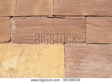 Sandstone Block Wall In Red And Yellow Shades For Background