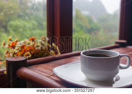 A Cup Of Coffee On An Old Bamboo Table With Nature Mountain View And Flowervase