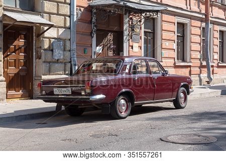St. Petersburg, Russia - August 17, 2019: Old Elegant Classic Soviet Car Gaz 24 Volga Scarlet In A C