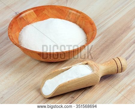 Baking Soda (sodium Bicarbonate). Soda In A Spoon And A Bowl On Wooden Table