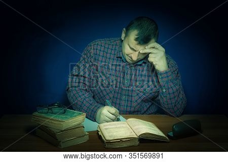 The Man Reads The Book. In The Head Images Similar To Reality Are Born. Fascinating Literary Work. T
