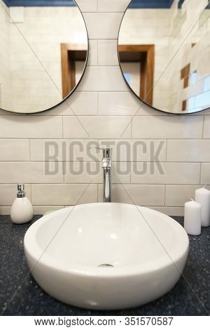 Bathroom In A Residential Building. Dressing Table With Mirrors. Sink With Candles And Soap. A Towel