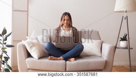 Online Life. Young Woman Chatting With Friend On Laptop At Home, Panorama