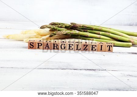 White And Green Asparagus On Background With Spargelzeit Wooden Letter.
