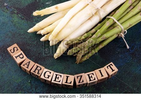 White And Green Asparagus On Background With Spargelzeit Wooden Letter.