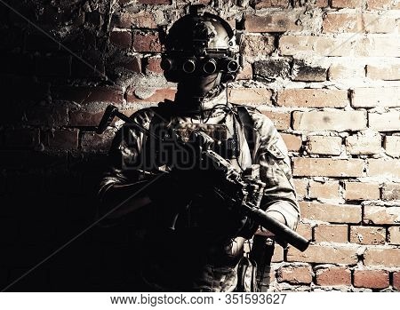 Army Special Forces Tactical Group Fighter In Cqb Mission, Using Radio Headset, Looking Through Four